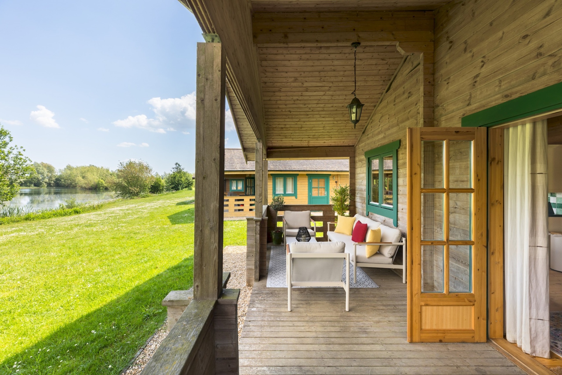 Primrose Lodge veranda looking across the grass to Lake Pochard