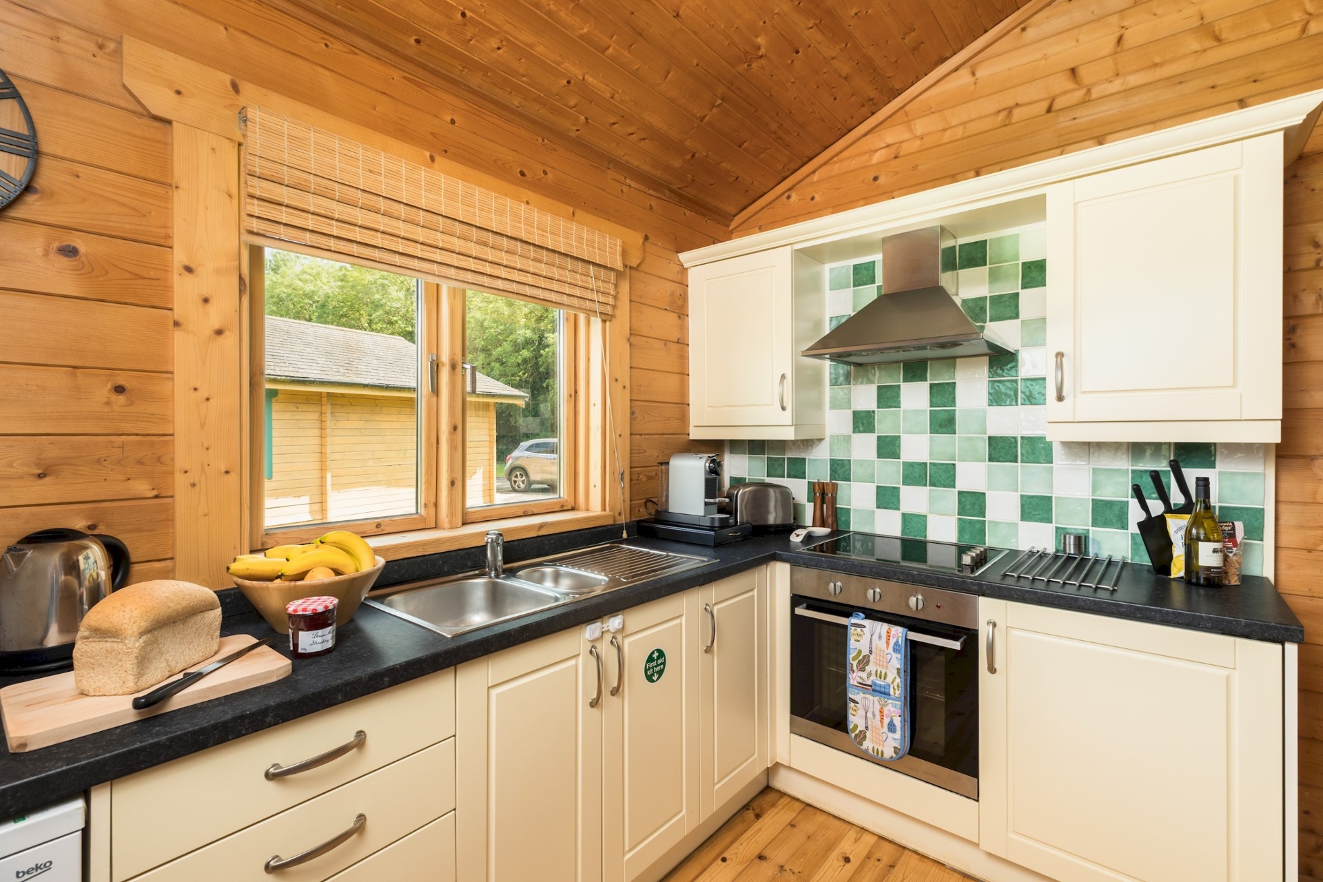 Kitchen at Primrose Lodge with sink, oven and view to the garden