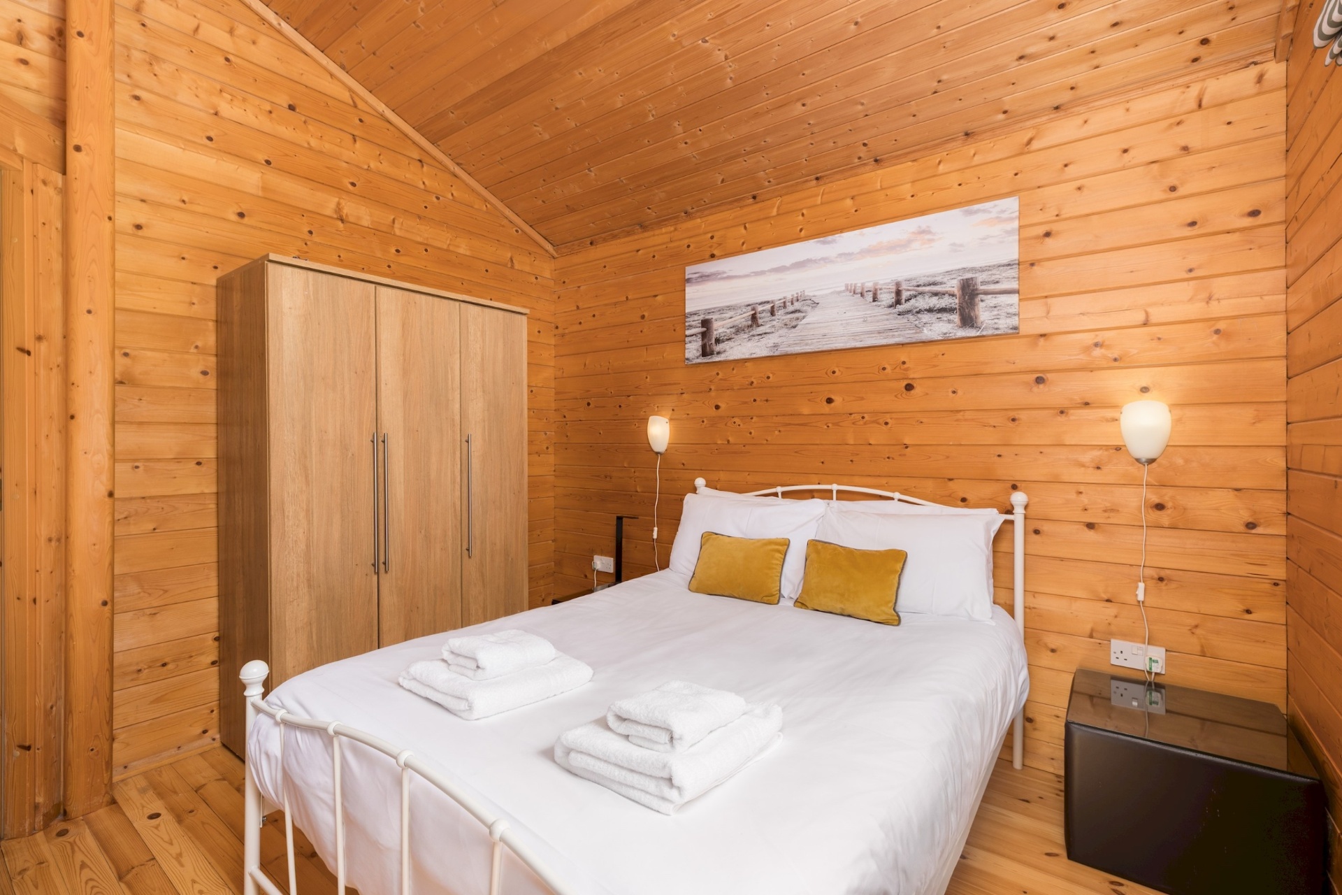 Main bedroom at Primrose Lodge with wardrobe and bedside lamp