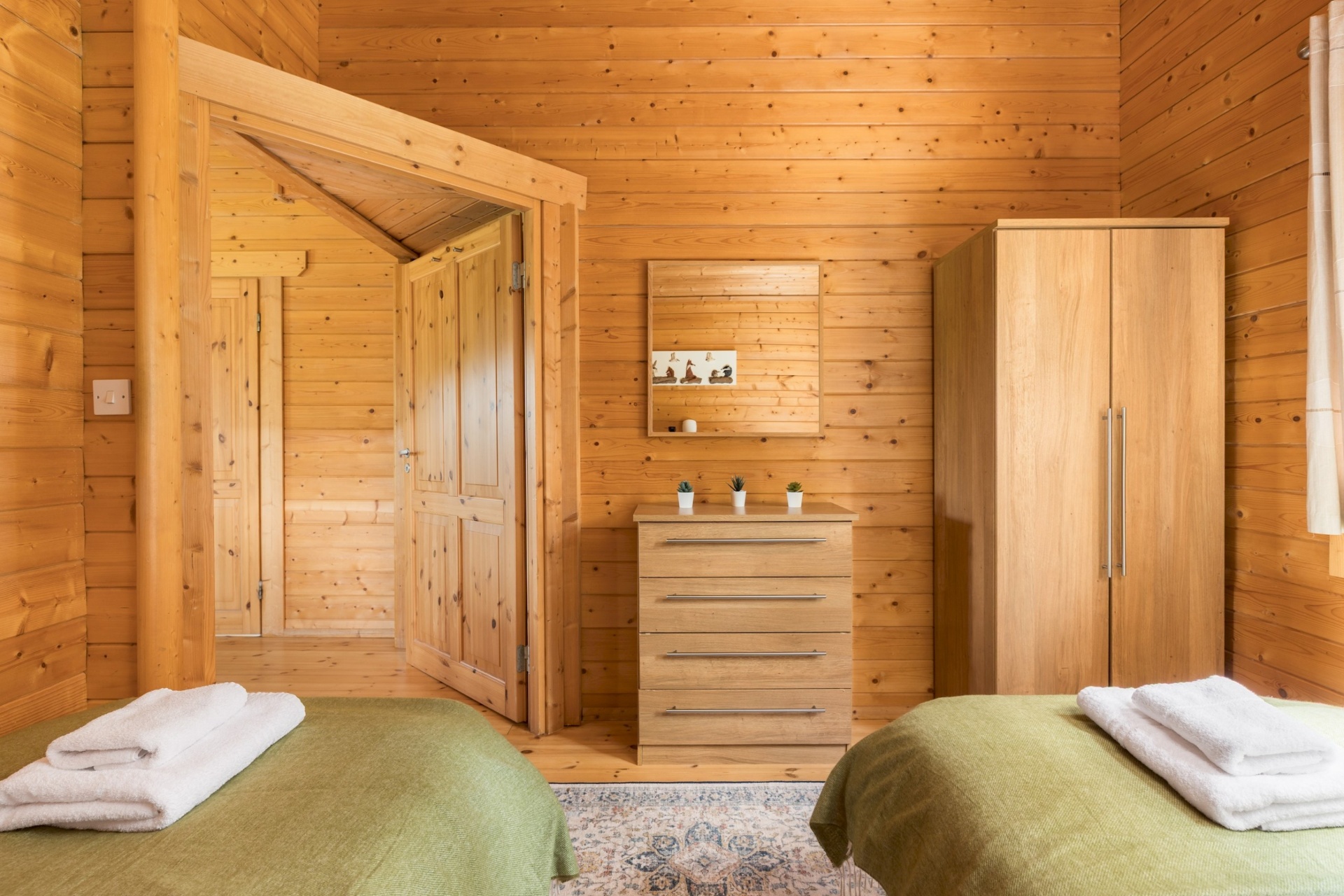 Twin bedroom dresser and wardrobe at Primrose Lodge
